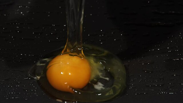 Cracking egg into frying pan