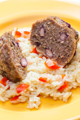 meat balls filled with red beans on rice with red pepper