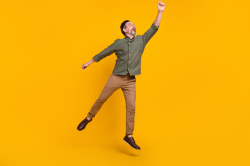 Full length body size view of attractive cheery dreamy man jumping holding copy space isolated over...