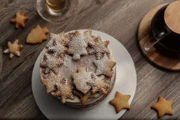 Chef or baker decorating cake with white whipped cream.Soft fokus