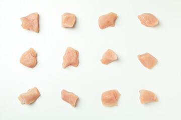 Flat lay composition with slices of raw chicken fillet on white background