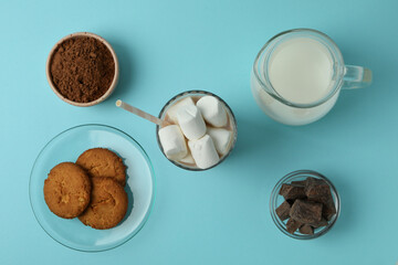 Concept of tasty drink with cocoa on blue background
