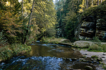 Fototapeta premium Bohemian Switzerland National Park, Czech Republic, 2 October 2021: Ruins of Dolsky mlyn at River Kamenice, old stone water mill at Ceske Svycarsko, autumn sunny day, abandoned building, old masonry