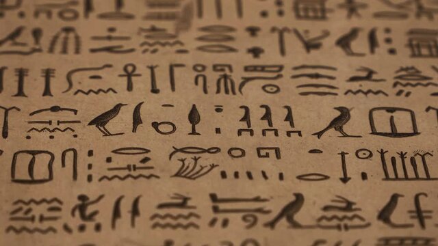 Ancient Egyptian hieroglyphs on brown paper
