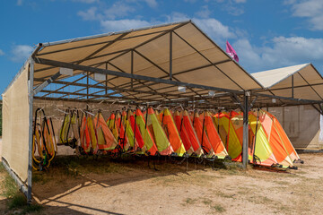 Alacati, Izmir, Turkey - August 25 2021:Windsurfing sails storage on a beach water sports facility.