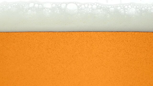 Close up background of beer with bubbles in glass