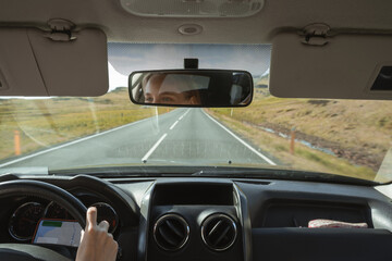 Female driver using navigation app while traveling to the destination through the Iceland
