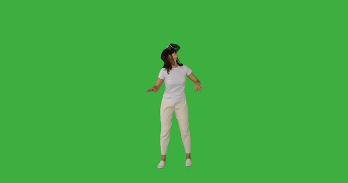 Woman doing hand gesture wearing vr glasses over green background