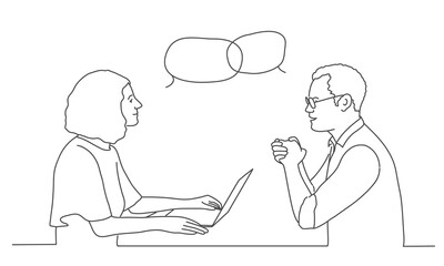 Woman with laptop and man with glasses talking in their office.