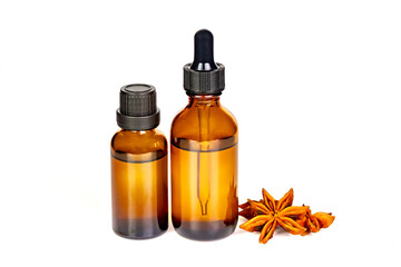 Anise essential extract aromatherapy oil in bottle with dry anise star flower isolated on white background.
