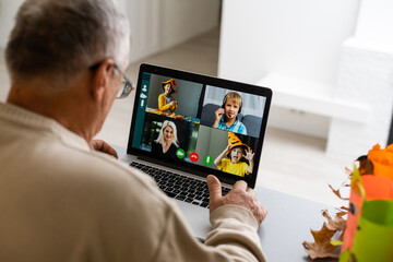 elderly man with laptop and video from grandchildren