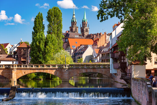 Sunny church and bridge over Pegnitz River in the Old Town of Nurnberg, eastern Bavaria, Germany