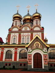 Fototapeta na wymiar Orthodox church with golden domes modern architecture