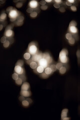 White bokeh lights in the dark. Christmas garland. 