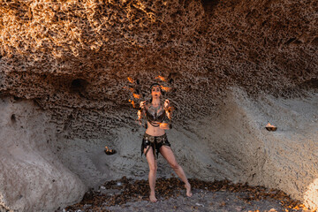 Woman dancing passionate dance with fire fan in his hand. Dancer in tribal style. Fire show.