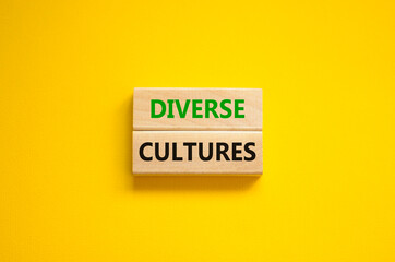 Time to diverse cultures symbol. Wooden blocks with words 'Diverse cultures'. Beautiful yellow background. Business and diverse cultures concept. Copy space.