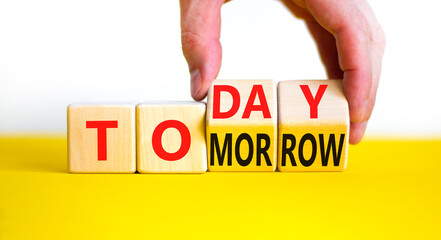 Do it today not tomorrow. Businessman turns wooden cubes and changes the word 'tomorrow' to...