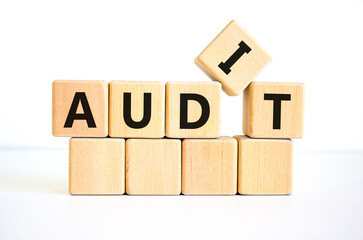 Audit symbol. The concept word 'audit' on wooden cubes. Beautiful white table, white background....