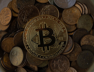 the bitcoin coin is in the piggy bank. lots of coins. finance.