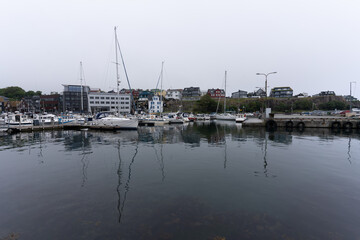 Fototapeta premium View of the beautiful city of Torshavan and its marina with sailing boats in the Faroe Islands 