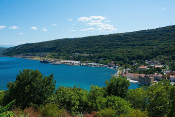 Fototapeta na wymiar The small town of Bakar in Primorje-Gorski Kotar County in western Croatia, with a cargo terminal on the left 