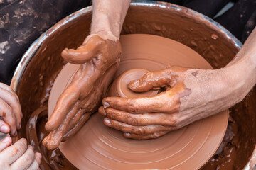 Master class on modeling of clay on a potter's wheel In the pottery workshop