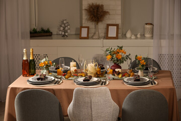 Table set with beautiful autumn decor for festive dinner in room