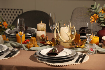 Table set with beautiful autumn decor for festive dinner