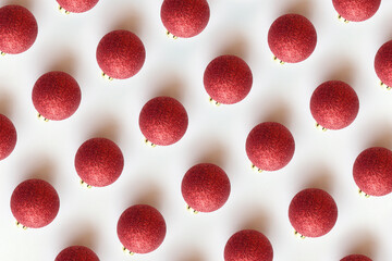 Minimal Christmas concept. Creative Christmas pattern made with red christmas ball decoration on a white background.