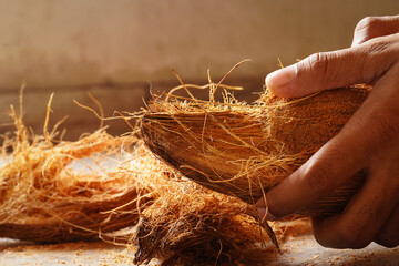 man peeling coconut from hand image indoor shoot