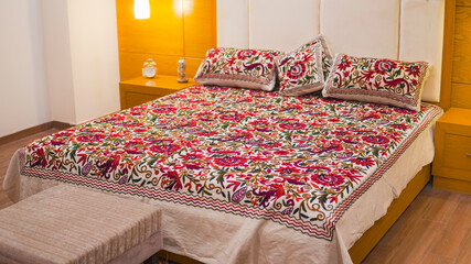 Contemporary Bed and beautiful Red flower bedsheet with white head board and golden background