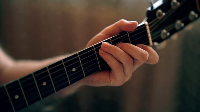 	Musician Playing Acoustic Guitar, Left Hand Shot