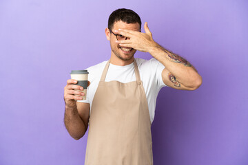 Brazilian restaurant waiter over isolated purple background covering eyes by hands and smiling