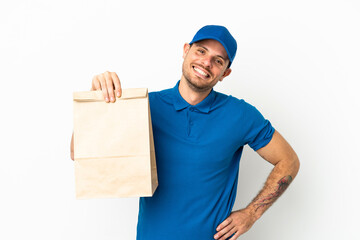 Brazilian taking a bag of takeaway food isolated on white background posing with arms at hip and smiling