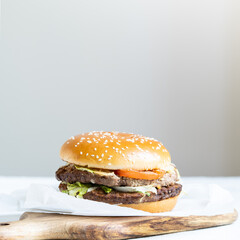 Double cheeseburger with veal cutlets, tomatoes, lettuce leaves and cucumbers. Fast food.