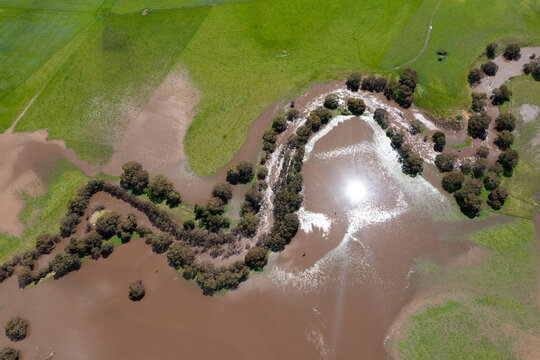 drone shot of farming landscape on a ranch in Australia, of a flooding river.