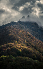 Mysterious autumn mountain with dramatic cloudy sky
