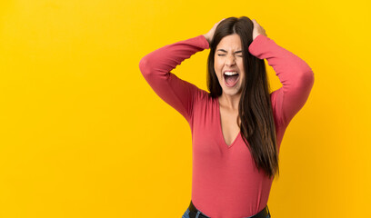 Teenager Brazilian girl over isolated yellow background stressed overwhelmed