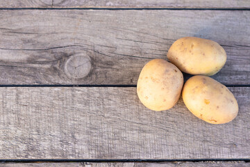 potatoes on a wooden background, concept agriculture.Copy space