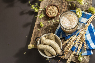 Oktoberfest set. Unfiltered beer, weisswurst, spikelets of grain, hop