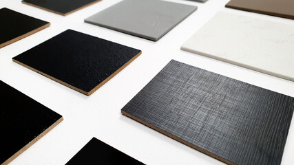 perspective view of multi surface of melamine samples in black color and multi color of grainy...