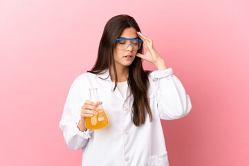Young scientific girl over isolated pink background with headache