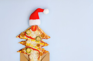 Delicious vegetarian Christmas tree pizza with tomatoes, vegetables and cheese on white background. Creative, funny food concept for kids. Top view, flat lay. Copy space. 
