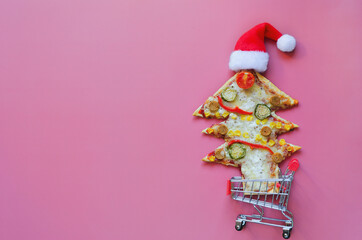 Delicious vegetarian Christmas tree pizza with tomatoes, vegetables and cheese on pink  background. Creative, funny food concept for kids. Top view, flat lay. Copy space. Template. Mock up.