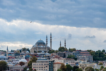 Istanbul cityscape with boats and Suleymaniye Mosque.