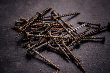 Old screws on a dark background