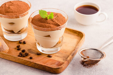 Traditional Italian dessert tiramisu in a glass.