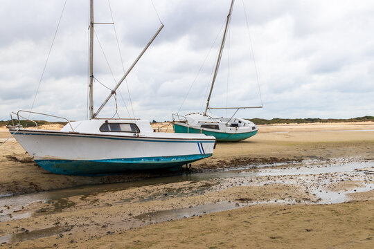 Boats on dry land at low tide