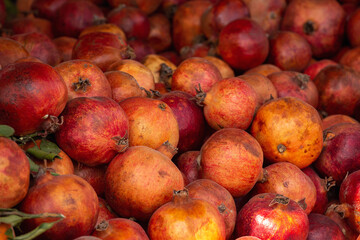 
Many fresh raw organic pomegranates in the market