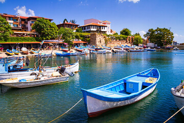 Fototapeta na wymiar Seaside cityscape - view of the pier with boats and embankment in the Old Town of Nessebar, on the Black Sea coast of Bulgaria